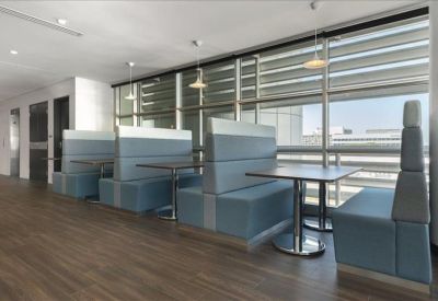 Sleek dining area with blue padded booth seating and pendant lighting.