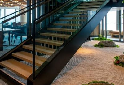 Modern staircase featuring a minimalist indoor zen garden with sand and moss.