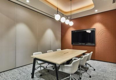 Contemporary meeting room with wood-paneled walls and a sleek conference table.