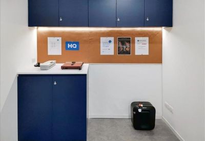 Modern blue reception desk in a bright, minimalist lobby.