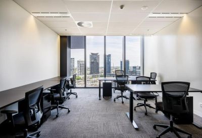 Private office suite with multiple workstations and floor-to-ceiling city views.