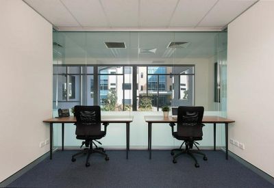 Two-person office with large windows and natural light.