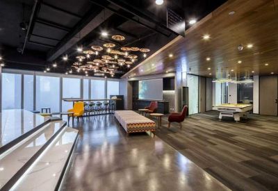 Stylish breakout lounge with a pool table, wooden ceiling, and modern lighting.