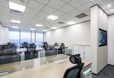 Clean office setting with a row of workstations and a large wall-mounted monitor.