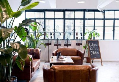 Lounge area featuring brown leather sofas and a chalkboard welcome sign.