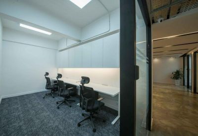 Internal three-person office suite with ergonomic chairs.