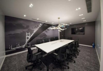 Professional conference room with a bridge mural and modern lighting.
