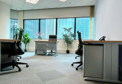 Professional reception desk area with wood panelling and a comfortable waiting lounge.
