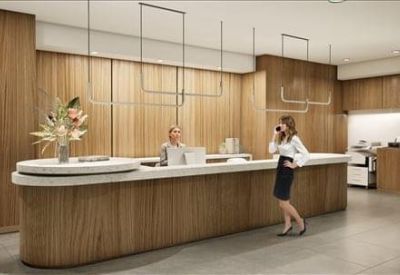 Reception area featuring a curved wood desk and warm wood-panelled walls.