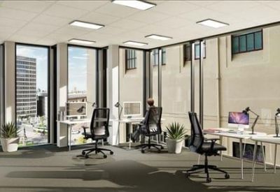 Open-plan office space with ergonomic chairs and views of the city skyline.