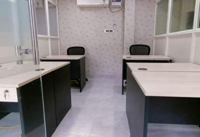 Private office suite with two separate wooden desks and ergonomic chairs.