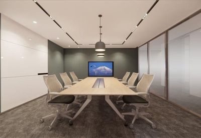 Professional boardroom with a long wooden table, grey chairs, and a large wall-mounted screen.