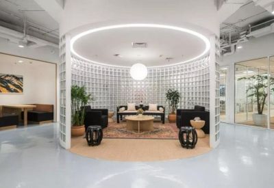 Circular lounge area with glass block walls and warm overhead lighting.