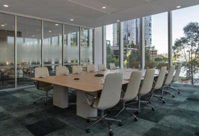 Spacious boardroom with a large table and city view.