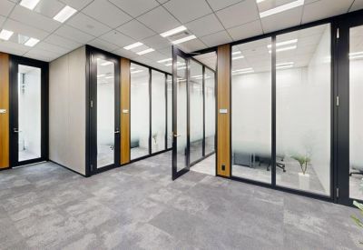 Corridor featuring a row of private phone booths with glass doors.