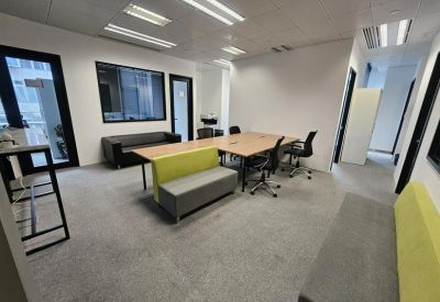 Open-plan workspace with long table and sofas.