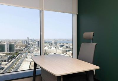 Professional workspace with an ergonomic chair and large window overlooking the city.