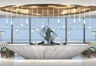 Spacious white marble reception desk with lounge seating and a circular ceiling feature.