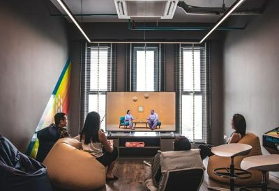 Cozy lounge area with bean bag chairs and a large television.