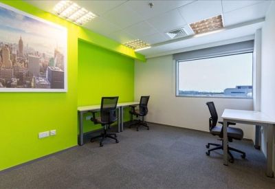 Private office suite with lime green feature wall and three workstations.