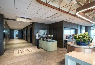 Sleek reception area with a curved desk, professional staff, and wood-paneled accents.