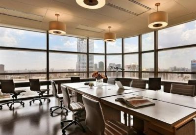 Bright corner office suite with wrap-around windows overlooking the city skyline.
