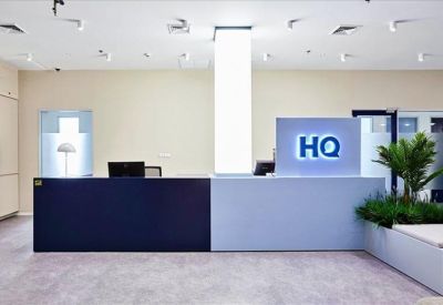 Modern reception area featuring a dual-tone blue and white desk with HQ branding.