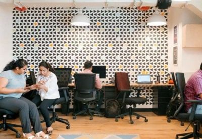 Open-plan workspace featuring a geometric pattern feature wall and ergonomic seating.