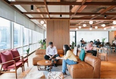 Lounge area with leather seating and wooden slatted feature wall under a decorative timber ceiling.