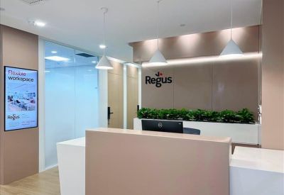 Sleek reception area at Liwang Square with a minimalist desk and branded signage.