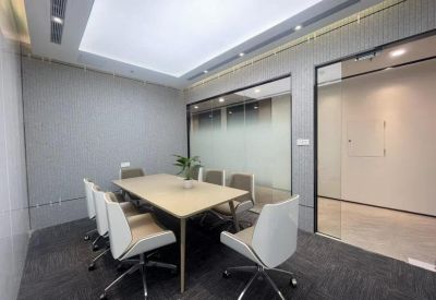 Modern meeting room featuring a light wood table and white ergonomic chairs.