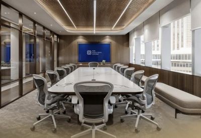 Spacious boardroom with a long white table, executive seating, and large windows.