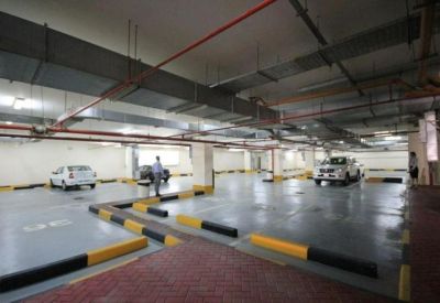 Spacious underground parking garage with clearly marked spaces.