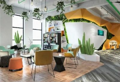 Spacious coworking lounge with diverse seating, vending machines, and lush vertical gardens.