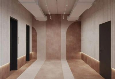 Modern hallway with arched wood accents and integrated floor lighting.