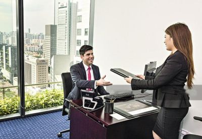 Private office with a large window showing city views and a glass-top desk.