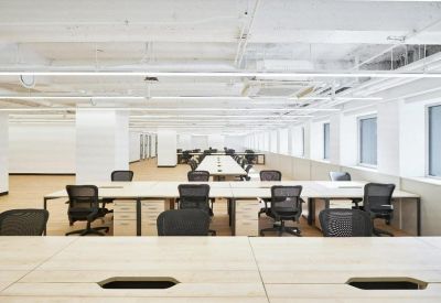 Rows of professional workstations in a clean, brightly lit corporate environment.