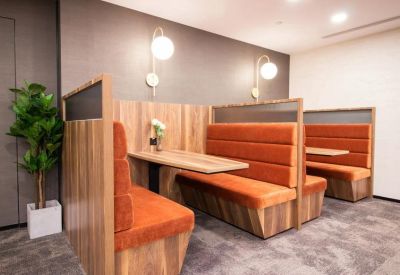 Comfortable orange booth seating for private meetings or dining.