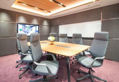 Conference room with a large wooden table and purple carpeting.