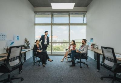 Small collaborative office space with natural light and a garden view.