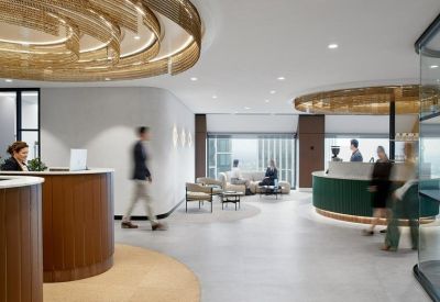 Professional reception area with wood-paneled desks and a decorative gold ceiling feature.