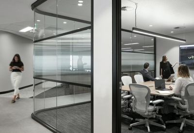 Glass-walled boardroom with ergonomic chairs and a sleek black frame design.