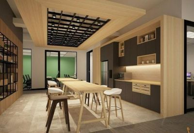 Modern communal kitchen and breakout area with high-top seating and wood accents.