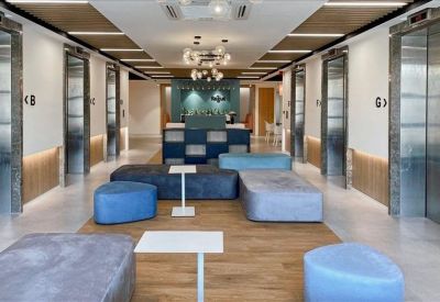 Spacious communal lounge area with blue and gray modular seating.