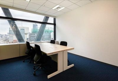 Private four-person office suite with a large window and city views.