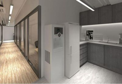 Clean office pantry and hallway with grey cabinetry and white appliances.