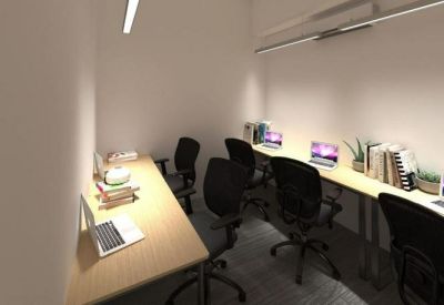 Compact private office with multiple workstations and black swivel chairs.