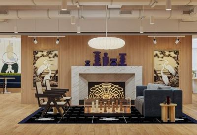 Communal lounge with a marble fireplace, dark seating, and bird-themed wall art.
