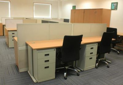 Professional workstation area featuring rows of desks with integrated storage drawers.