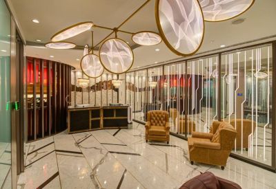 Reception area with marble floors and unique circular ceiling light fixtures.